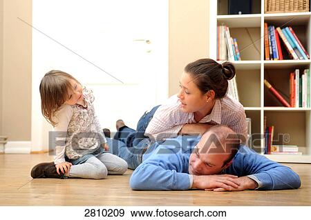 Couple playing with their daughter View Large Photo Image Stock Photo - Couple playing with their daughter . Fotosearch
