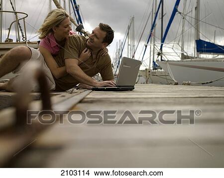 Couple romancing at harbor View Large Photo Image Picture - Couple romancing at harbor . Fotosearch