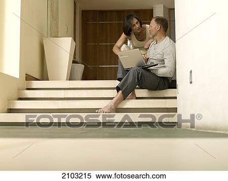 Stock Photography - Couple talking on steps . Fotosearch