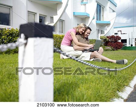 Couple using laptop at front yard View Large Photo Image Stock Image - Couple using laptop at front yard . Fotosearch