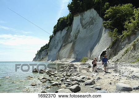 Couple walking at coast View Large Photo Image Stock Image - Couple walking at coast . Fotosearch