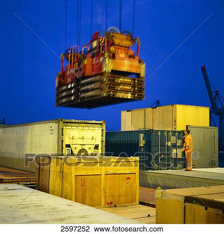 Crane hoisting container at harbor View Large Photo Image Stock Image - Crane hoisting container at harbor . Fotosearch