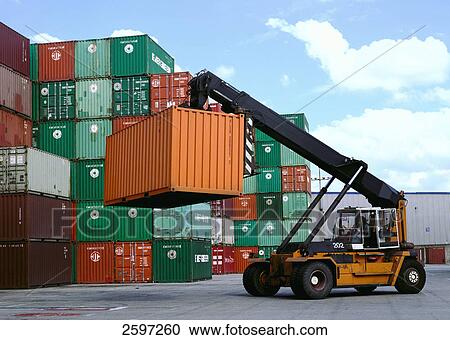 Crane hoisting container at harbor View Large Photo Image Stock Image - Crane hoisting container at harbor . Fotosearch