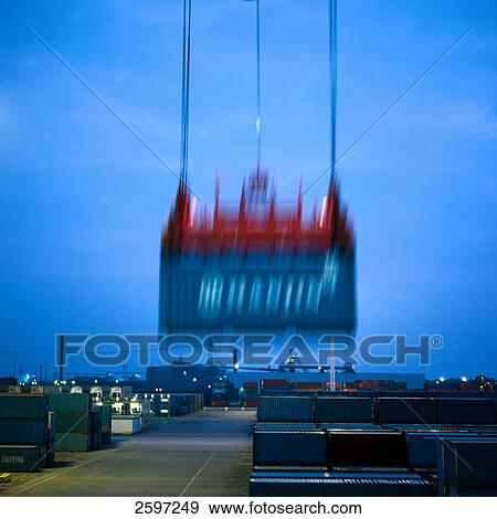 Crane hoisting container at harbor View Large Photo Image Stock Photo - Crane hoisting container at harbor . Fotosearch
