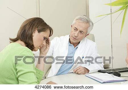 Stock Photograph - Depressed woman at the doctor . Fotosearch