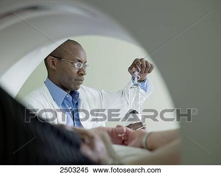 Stock Photography - Doctor adjusting x-ray machine . Fotosearch