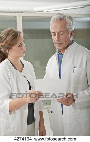 Doctor and doctor's assistant talking View Large Photo Image Picture - Doctor and doctor's assistant talking . Fotosearch