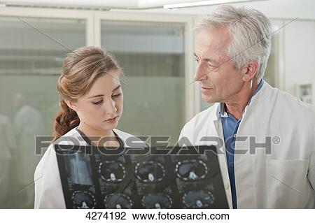 Stock Image - Doctor and doctor's assistant with x-ray . Fotosearch