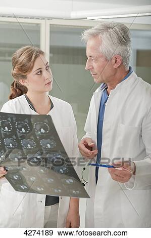 Stock Photo - Doctor and doctor's assistant with x-ray . Fotosearch