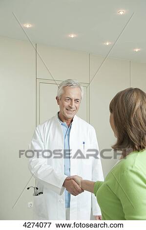 Doctor and female patient shaking hands View Large Photo Image Stock Photo - Doctor and female patient shaking hands . Fotosearch