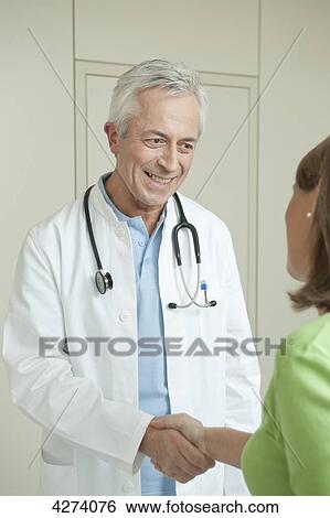 Doctor and female patient shaking hands View Large Photo Image Stock Photograph - Doctor and female patient shaking hands . Fotosearch