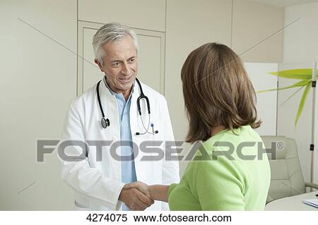 Doctor and female patient shaking hands View Large Photo Image Stock Photography - Doctor and female patient shaking hands . Fotosearch