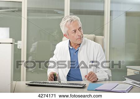 Doctor at desk drinking liquor secretly View Large Photo Image Stock Image - Doctor at desk drinking liquor secretly . Fotosearch