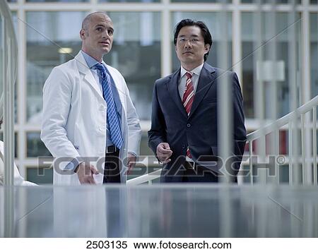 Stock Photography - Doctor discussing with businessman . Fotosearch