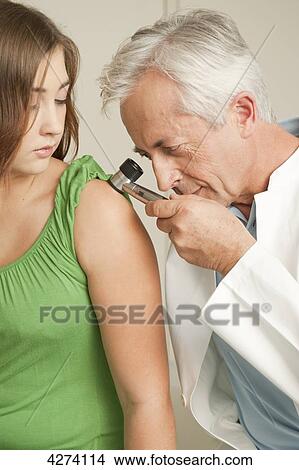 Picture - Doctor examining patient's arm . Fotosearch