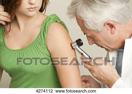 Doctor examining patient's arm View Large Photo Image Stock Image - Doctor examining patient's arm . Fotosearch