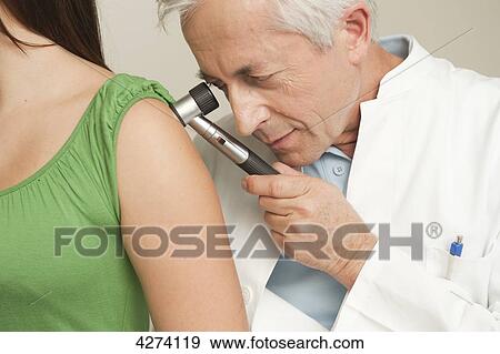 Doctor examining patient's arm View Large Photo Image Stock Photo - Doctor examining patient's arm . Fotosearch