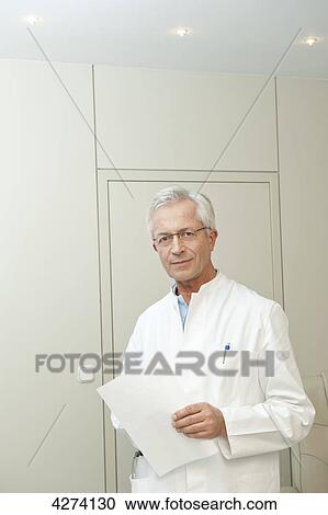 Doctor holding document View Large Photo Image Stock Image - Doctor holding document . Fotosearch