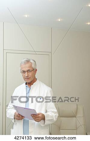 Stock Image - Doctor holding document . Fotosearch