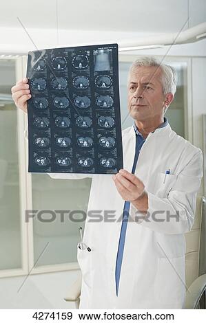 Stock Photo - Doctor looking at x-ray . Fotosearch