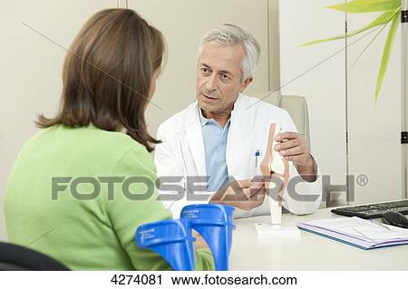 Doctor showing female patient artificial knee joint View Large Photo Image Stock Image - Doctor showing female patient artificial knee joint . Fotosearch