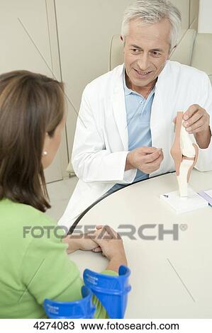 Doctor showing female patient artificial knee joint View Large Photo Image Stock Image - Doctor showing female patient artificial knee joint . Fotosearch