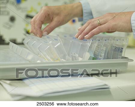 Doctor taking medicine from medical tray View Large Photo Image Stock Photograph - Doctor taking medicine from medical tray . Fotosearch