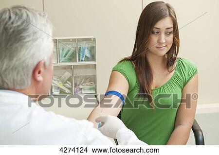 Doctor taking patient's blood sample View Large Photo Image Picture - Doctor taking patient's blood sample . Fotosearch