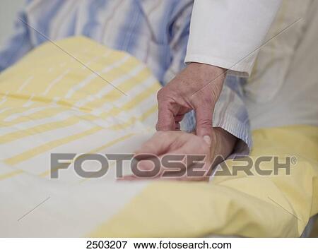 Doctor taking pulse of patient View Large Photo Image Stock Photo - Doctor taking pulse of patient . Fotosearch