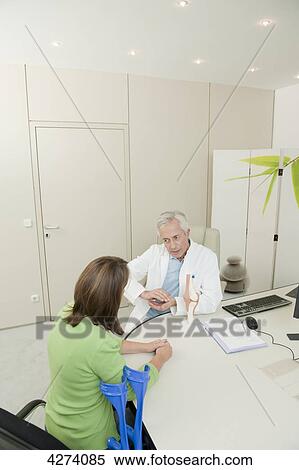 Doctor talking to female patient View Large Photo Image Stock Photography - Doctor talking to female patient . Fotosearch