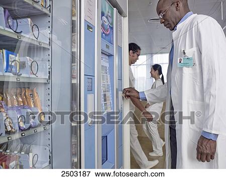 Stock Photo - Doctor using coffee machine . Fotosearch