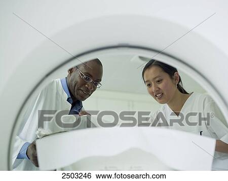 Stock Photograph - Doctors checking patient before MRI scan . Fotosearch