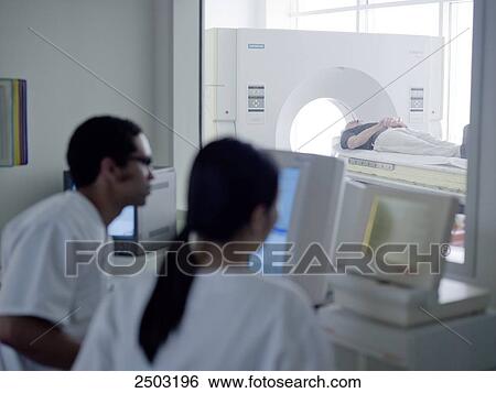 Doctors examining MRI report on computer View Large Photo Image Stock Photograph - Doctors examining MRI report on computer . Fotosearch