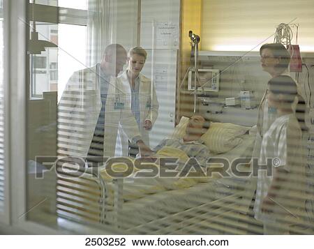 Doctors examining patient in hospital View Large Photo Image Stock Image - Doctors examining patient in hospital . Fotosearch