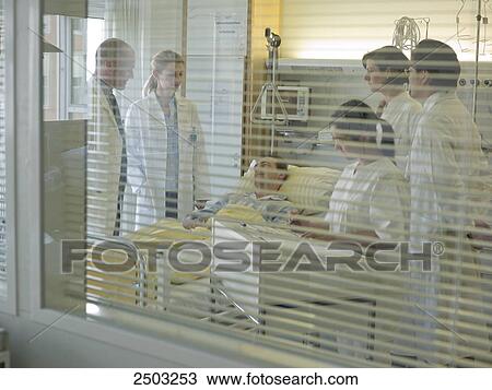 Doctors examining patient in hospital View Large Photo Image Stock Image - Doctors examining patient in hospital . Fotosearch