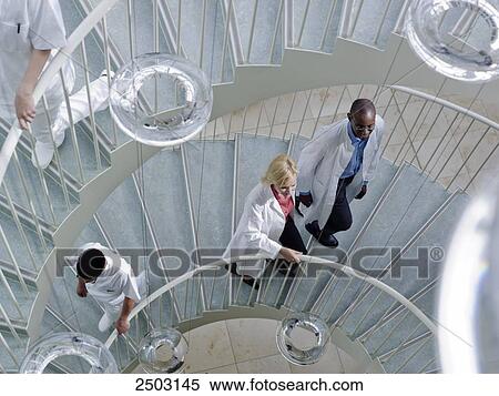 Doctors moving on spiral staircase View Large Photo Image Stock Photography - Doctors moving on spiral staircase . Fotosearch