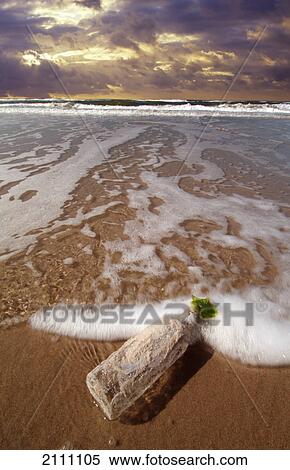 Empty bottle on beach View Large Photo Image Stock Photography - Empty bottle on beach . Fotosearch