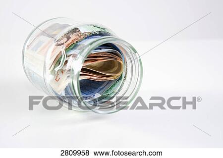 Euro bills in glass container View Large Photo Image Stock Photo - Euro bills in glass container . Fotosearch