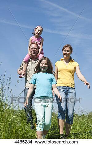 Family going over meadow View Large Photo Image Picture - Family going over meadow . Fotosearch