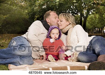Family with toddler relaxing in park View Large Photo Image Stock Photography - Family with toddler relaxing in park . Fotosearch