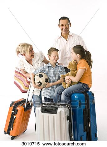 Family with two children with luggage, studio shot View Large Photo Image Stock Photography - Family with two children with luggage, studio shot . Fotosearch