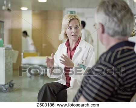 Stock Photograph - Female doctor explaining to male patient . Fotosearch