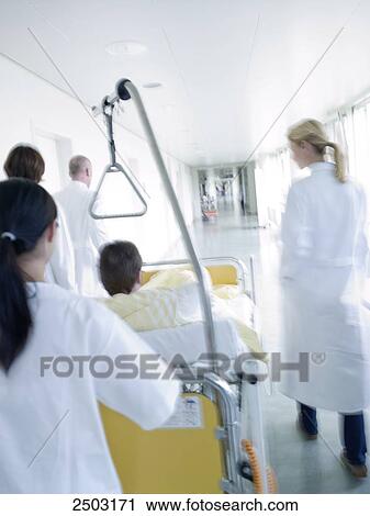 Female nurse pushing patient on gurney View Large Photo Image Stock Image - Female nurse pushing patient on gurney . Fotosearch