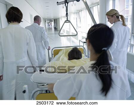 Female nurse pushing patient on gurney View Large Photo Image Stock Image - Female nurse pushing patient on gurney . Fotosearch