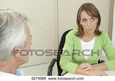 Stock Photo - Female patient at the doctor thinking . Fotosearch