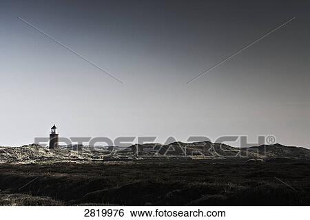 Stock Photograph - Field with lighthouse in background, Sylt, Schleswig-Holstein, Germany . Fotosearch
