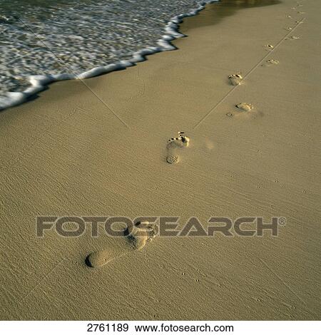 Stock Photo - Footprints on beach . Fotosearch