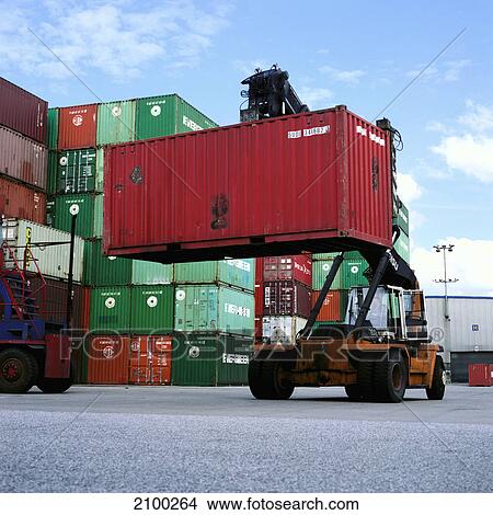 Picture - Forklift lifting cargo container at port, Hamburg, Germany . Fotosearch
