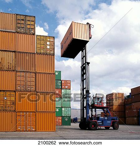 Forklift lifting cargo container at port, Hamburg, Germany View Large Photo Image Stock Image - Forklift lifting cargo container at port, Hamburg, Germany . Fotosearch