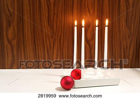 Four candles burning near baubles View Large Photo Image Stock Photo - Four candles burning near baubles . Fotosearch